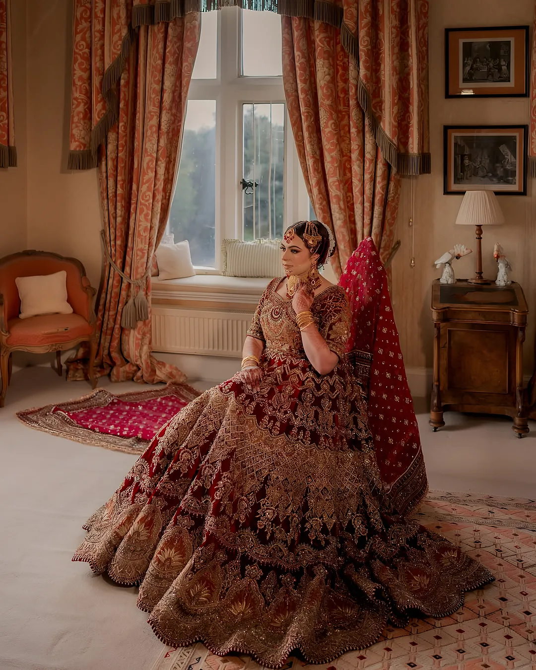 Bride seated in a floral period room