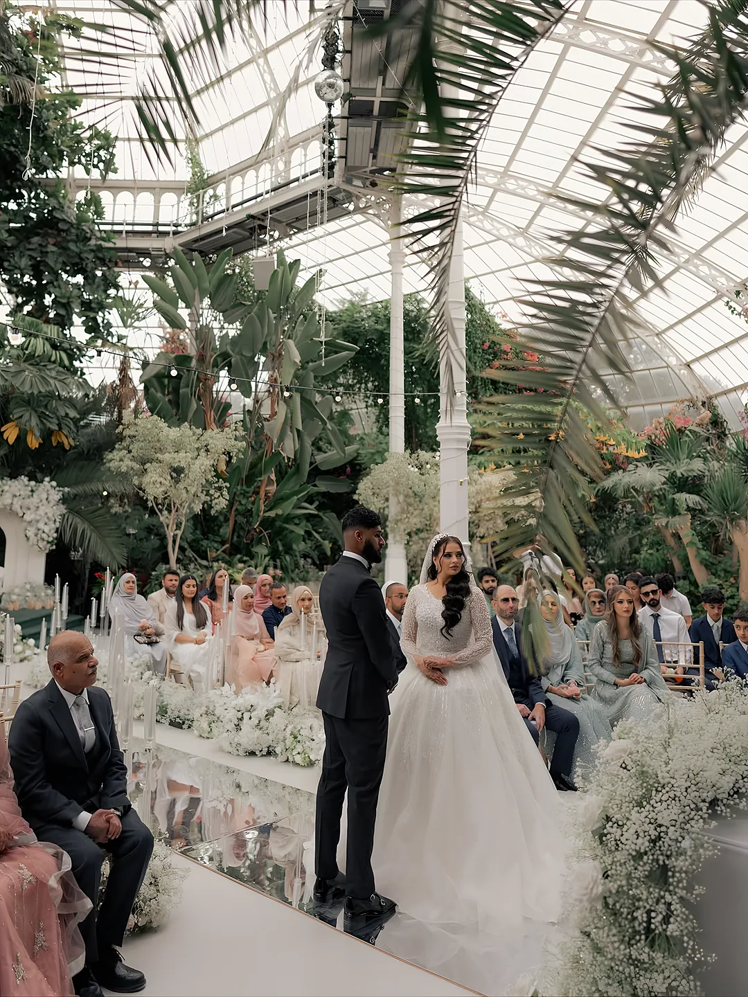 Wedding ceremony inside a glasshouse venue