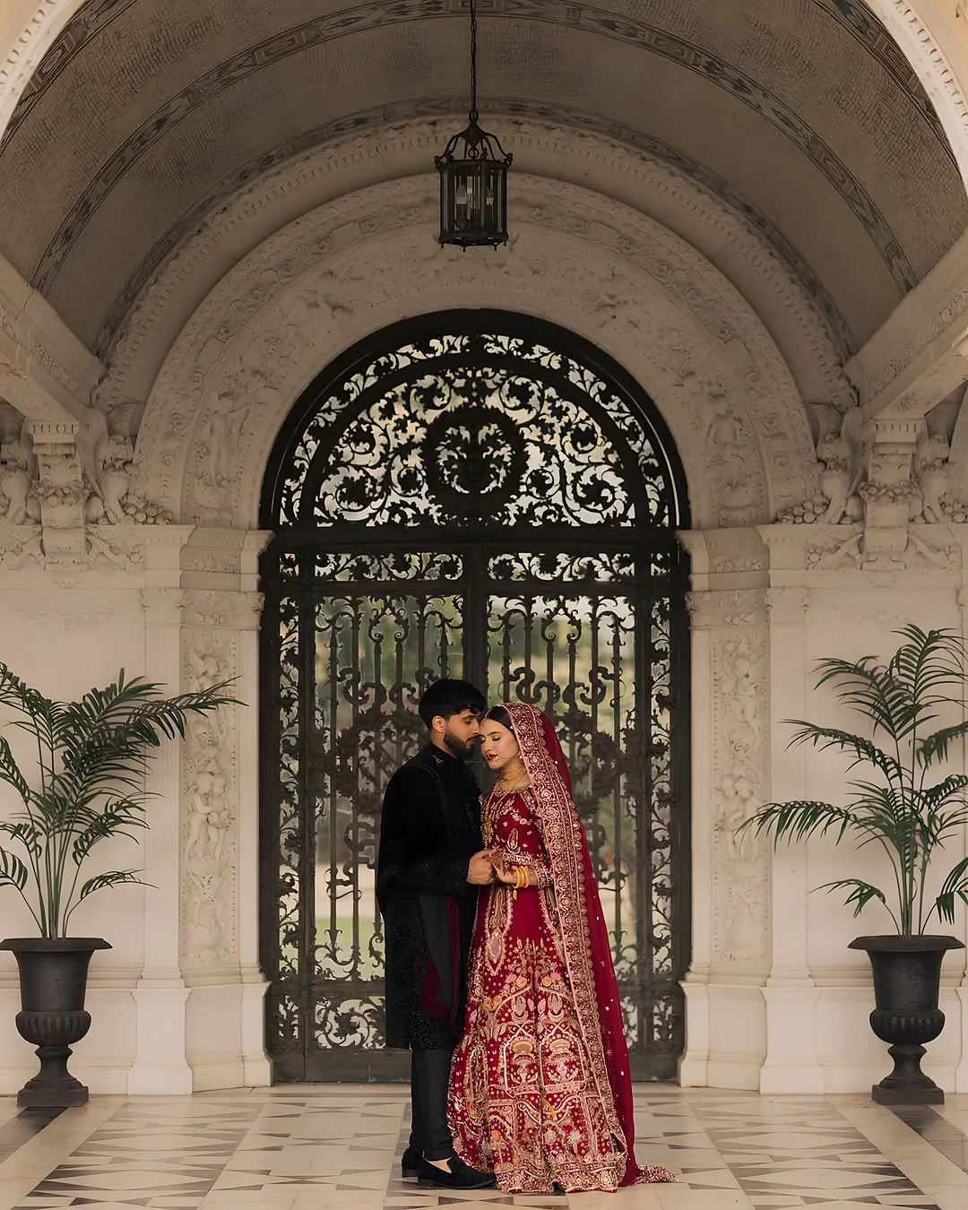 Couple framed by an iron gate