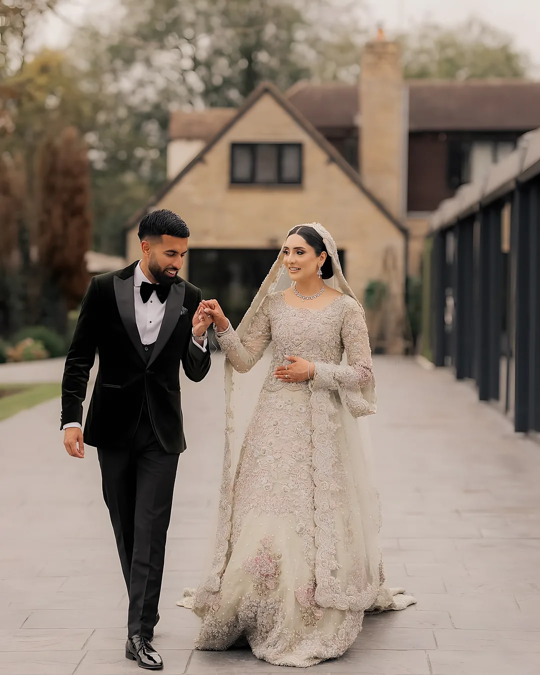 Couple walking hand in hand on a country estate